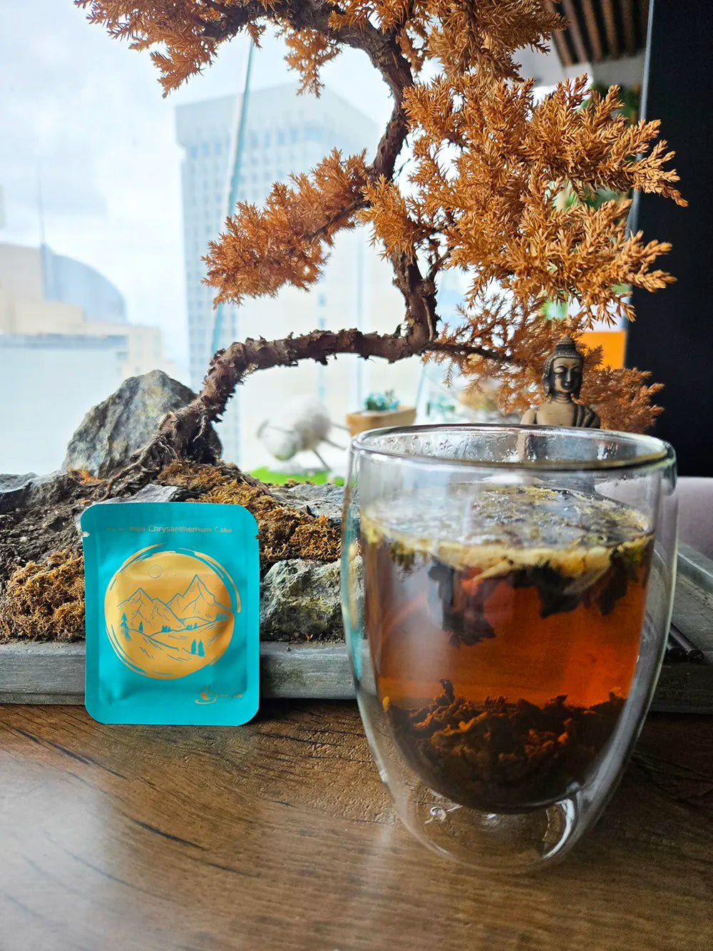 chrysanthemum puer cake with bonsai tree and cup